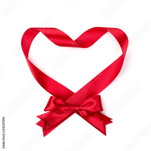 Shape of heart made of red ribbon with bow isotated on white. Top view.