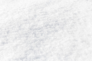 Fresh fluffy snow texture background. Side angle view with perspective