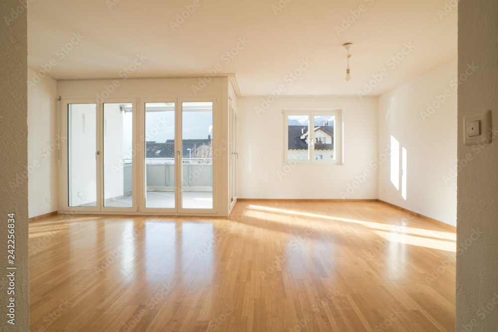bright new living room in an empty apartment with french doors and parquet wooden floors - obrazy, fototapety, plakaty 