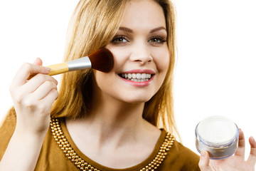 Smiling woman holding make up brush