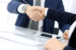© rogerphoto - Group of business people or lawyers shaking hands finishing up a meeting , close-up. Success at negotiation and handshake concepts
