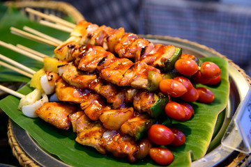 Wall Mural - Grilled pork with BBQ sauce on sticks, thailand street food