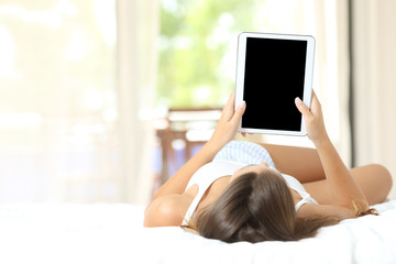 Canvas Print - Girl on the bed showing a blank tablet screen