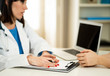 © SB Arts Media - Close up of woman doctor and patient having consultation in hospital room