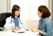 © SB Arts Media - Female specialist doctor listening to woman patient explaining her symptoms and health problems