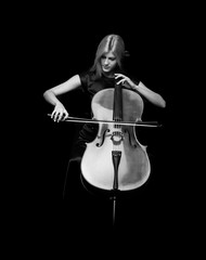 Wall Mural - Young girl playing the cello on isolated black background