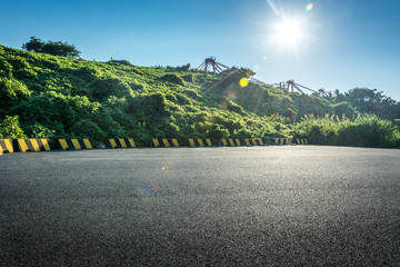 Wall Mural - Empty parking lot with forest and beautiful blue sky.