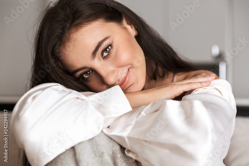 Image of beautiful woman 30s wrapped in blanket smiling, and sitting on couch in Poster Mural XXL