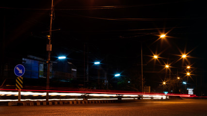 Car headlights and night street lamps.