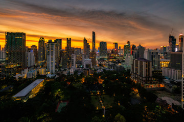Wall Mural - Aerial view of Bangkok skyline and skyscraper with sunset sky on Sukhumvit road center of business in Bangkok city downtown Thailand.