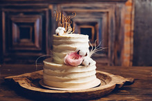 Rustic Style Wedding Cake With Cotton And Floral Decoration.
