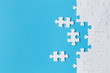 © Yeti Studio - White puzzle pieces on blue background