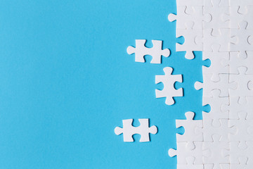 White puzzle pieces on blue background