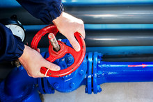 The Hands Of The Worker Unscrew Rotate The Red Valve To Supply The Gas Supply.