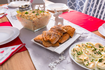 Wall Mural - Christmas dinner table with fried salmon fillets and eggs mayonnaise