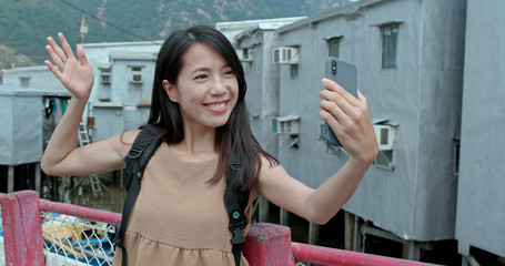 Poster - Woman take selfie in Tai O village of Hong Kong