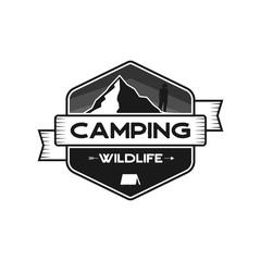 Wall Mural - Camping Wildlife Badge. Mountain adventure emblem in silhouette retro style. Featuring mountains and hiker, camper man. Travel logo, patch. Stock vector hiking label isolated on white background