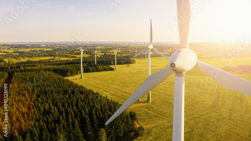 Cuadros en Lienzo Wind turbines and agricultural fields on a summer day - Energy Production with c