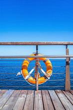 Swimming Ring On The Railing Of The Boardwalk