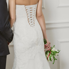 Wall Mural - Elegant bride and groom posing together in studio on a wedding day.