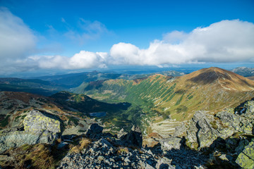 rocky Tatra mountain tourist hiking trails under blue sky in Slovakia