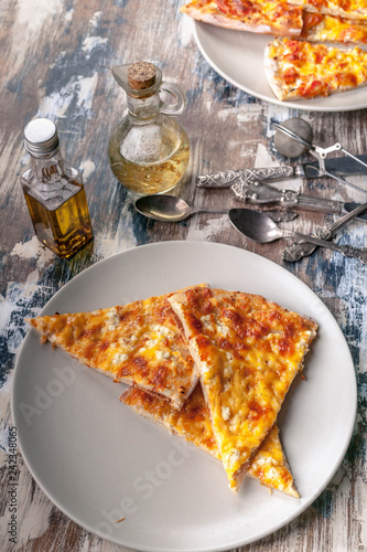 Fotografie, Obraz Tasty pizza on a plate on a wooden table