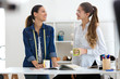 © nenetus - Two pretty young businesswomen drinking coffee while taking a break in a sewing workshop.