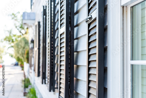 Fotografie, Obraz Black decorative row of window shutters closeup architecture open exterior of ho