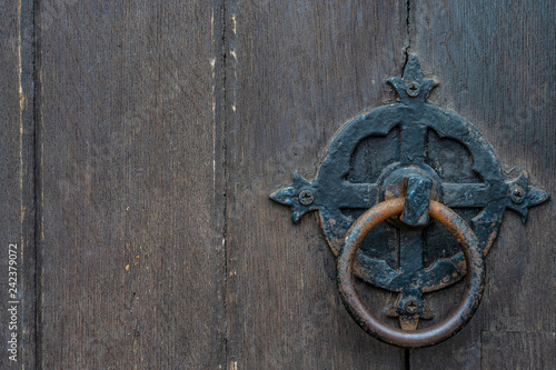 Fotografie, Obraz Vintage black door panels with ancient knocker - high quality texture / backgrou