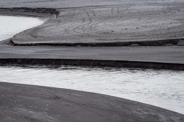  Myrdal, Iceland Reynisfjara black sand beach unique river stream formation and volcanic seashore coast, nobody