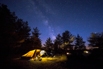 family tent on camping ground under stars