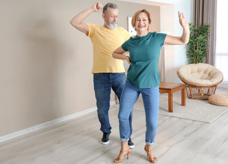 Poster - Happy mature couple dancing at home