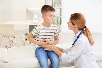 Wall Mural - Doctor working with little patient in hospital