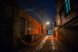 Fototapeta Uliczki - Dark and eerie industrial urban city alley with dumpsters at night in Chicago