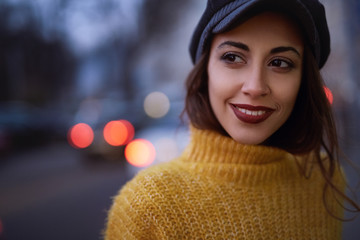 Wall Mural - portrait of a beautiful fashionable stylish woman in bright yellow sweater and skirt walking and posing outdoors at evening, street style shooting