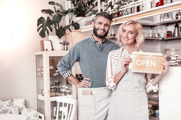 Delighted happy young couple opening their own cafe