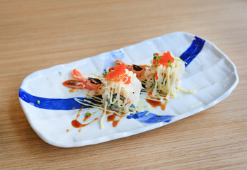 Wall Mural - Shrimp sushi with egg in plate on wooden table. Traditional Japanese food.