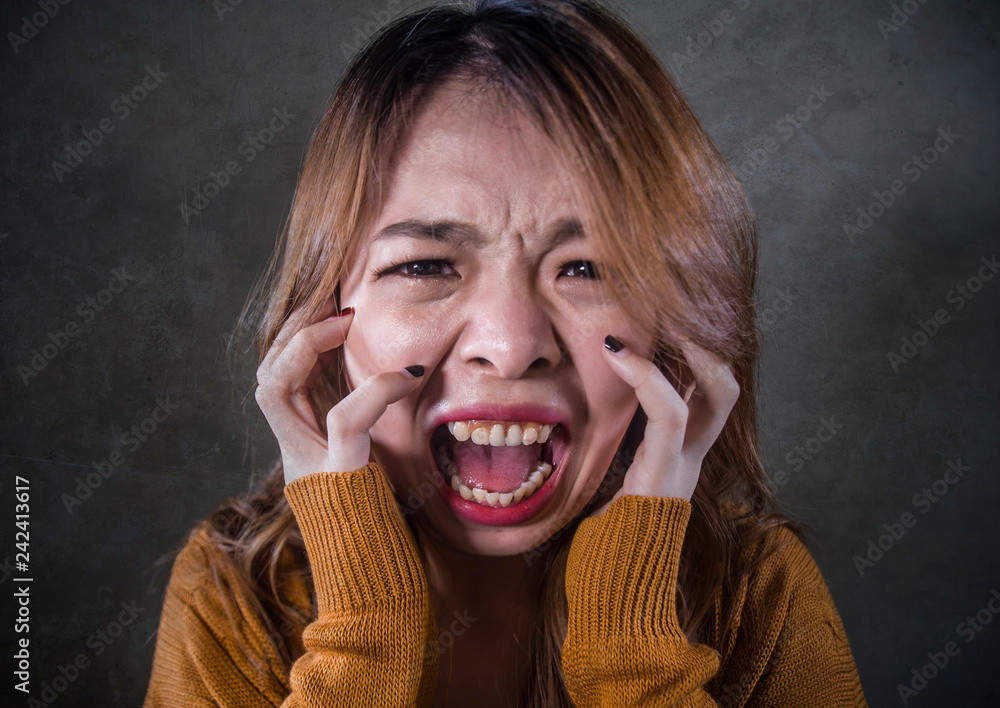 young crazy desperate and upset Asian Korean woman screaming scared and ...