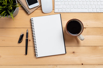 Top view empty notebook and coffee with computer on wooden table ,top view