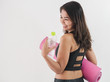 © nuiiko - Happy Asian woman holding a bottle of water and pink yoga mat, lifestyle