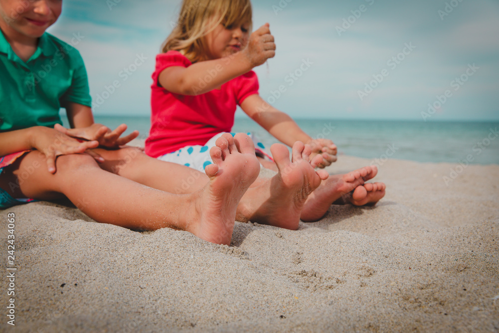 little boy and girl play with sand on beach Stock Photo | Adobe Stock