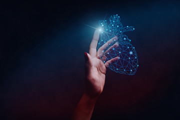 Poster - Human forefinger touches blue heart innovative technologies. Nebula dust  in infinite space. Mixed media.