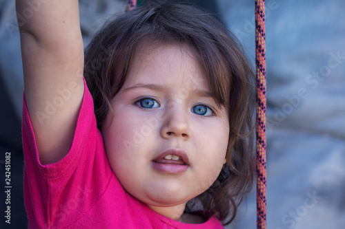 Portrait Of A Cute Girl With Short Curly Hair Of Caucasian