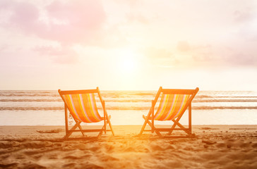 Couple of deck chairs on empty sea beach. Tropical spa resort in exotic country. Vacation travel to Thailand