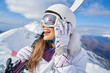 © ZoomTeam - Woman Skier Standing at Snow Looking at Camera. Winter Montain background