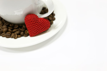 Wall Mural - Romantic breakfast in Valentine day, cup of coffee, red knitted heart and coffee beans isolated on white. Concept of  love, happy morning, healthy drink