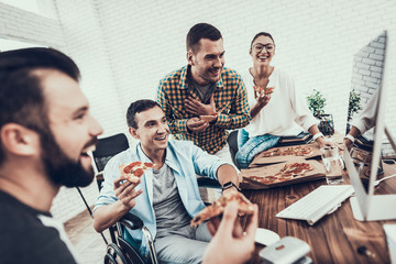 Wall Mural - Young People Have Lunch with Pizza in Office.