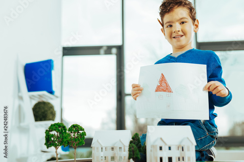 Fotografie, Obraz Little boy feeling proud while showing his picture