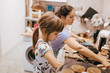 © Leika production - Mother and her little daughter cooking pancakes for the breakfast in the little cozy kitchen