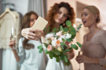 Wall Mural - Young ladies making selfie in wedding salon